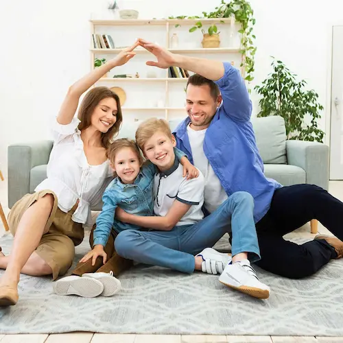 family smiling sitting on floor